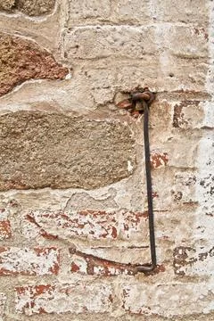Ancient door hook with trace on stone wall. Stock Photos
