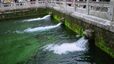 Ancient Dragon Head Spouts Gushing Water at Black Tiger Spring Stock Footage 331216092