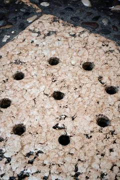 Ancient drainage system in the concrete surface of the street Stock Photos