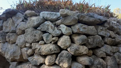 Ancient dry stone cabin surrounded by Mediterranean vegetation Stock Footage 344803343