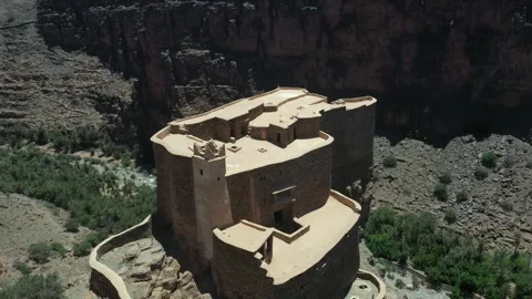 Ancient Earthen Fortress Perched on Rocky Cliff Face Stock Footage 335636588