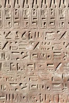 Ancient Egyptian hieroglyphs on stone wall, Karnak Temple Complex, Luxor, E.. Stock Photos