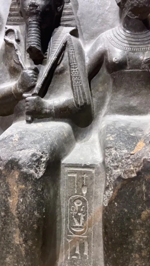 Ancient egyptian pharaoh and queen statue in dark stone on April 14, 2026 in Stock Footage 332820203