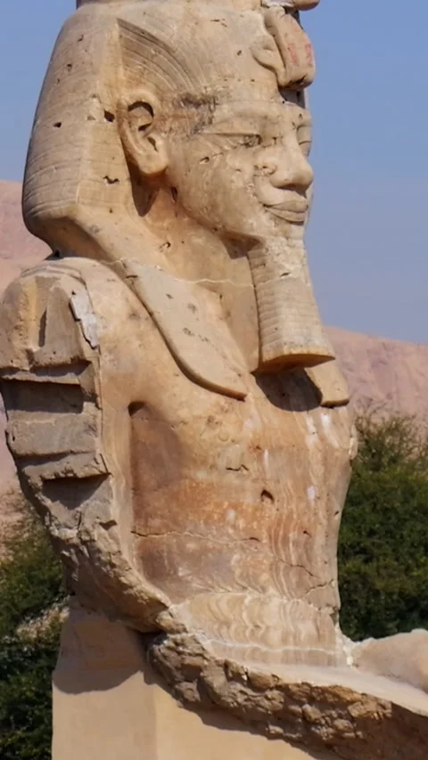 Ancient Egyptian pharaoh statue with royal headdress and hieroglyphs against Stock Footage 337501309