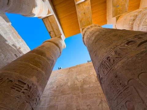 Ancient Egyptian temple columns featuring  detailed hieroglyphics Stock Photos