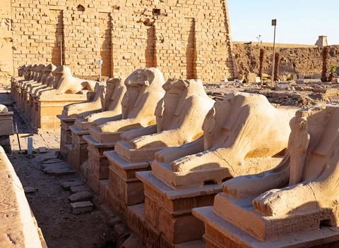 Ancient Egyptian temple featuring rows of ram statues Stock Photos