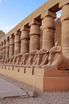 Ancient Egyptian temple featuring rows of ram Stock Photos