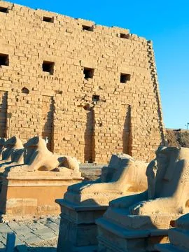 Ancient Egyptian temple featuring rows of ram statues Stock Photos
