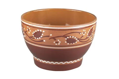 Ancient empty brown handmade clay clay bowl with closeup drawings isolated on Stock Photos