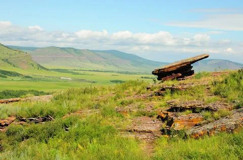 An ancient flat sacrificial stone at the top of a sacred mountain. Stock Photos