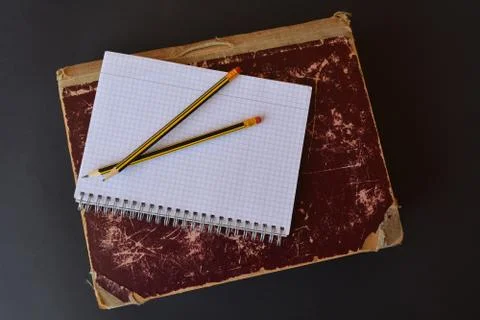 Ancient folio with a blank notepad and pencils Stock Photos