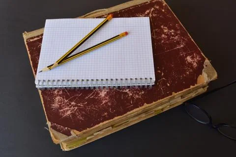 Ancient folio with a blank notepad and pencils Stock Photos