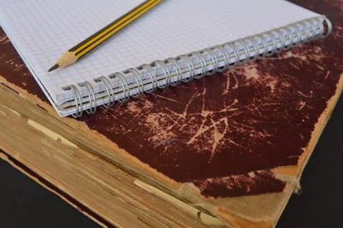 Ancient folio with a blank notepad and a pencil Stock Photos
