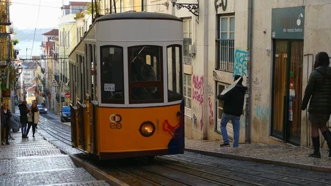 The ancient funicular carries passengers on the steep streets of central Lisbon Stock Footage 88262822