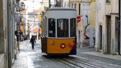 The ancient funicular carries passengers on the steep streets of central Lisbon Stock Footage 88263023