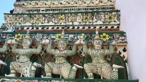 Ancient giant deity statue around the base of pagoda of Wat Arun Stock Footage 125521845