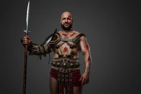 Ancient gladiator with long spear and naked torso Stock Photos