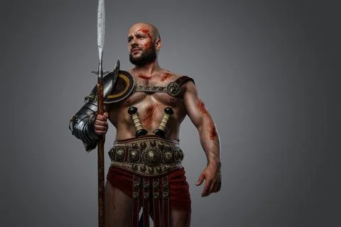 Ancient gladiator with long spear and naked torso 스톡 사진