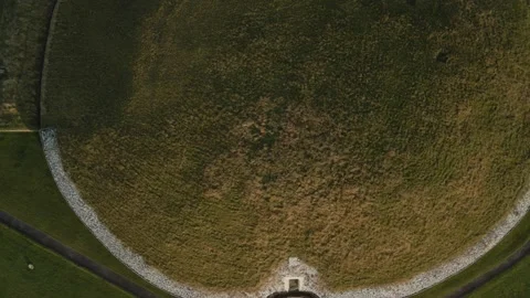 Ancient grass-covered mound with circular patterns in Ireland seen from above Stock Footage 294698208