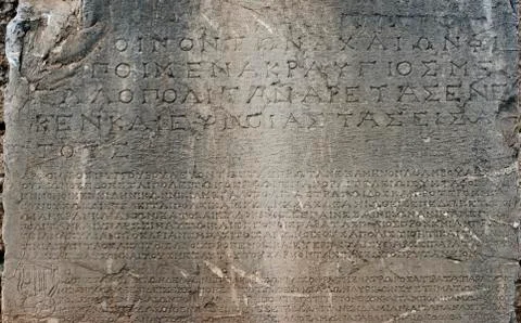 Ancient greek script carved on stone plate, delphi, greece Stock Photos