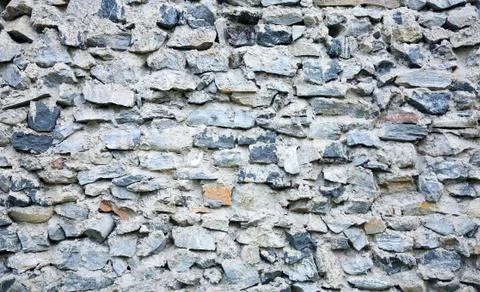 Ancient grunge rough stone wall Stock Photos