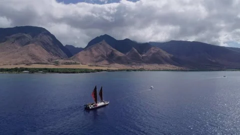 Ancient Hawaiian sailboat sails off the coast of Maui Hawaii. Stock Footage