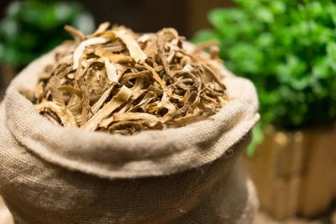 Ancient herbs in sacks on a table made of wood. Stock Photos