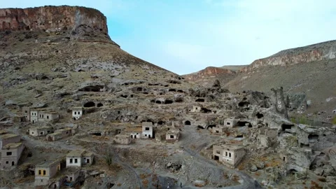 Ancient Hillside Settlement. Historic rock town Nestled in Eroded Tunnels Stock Footage 339636298
