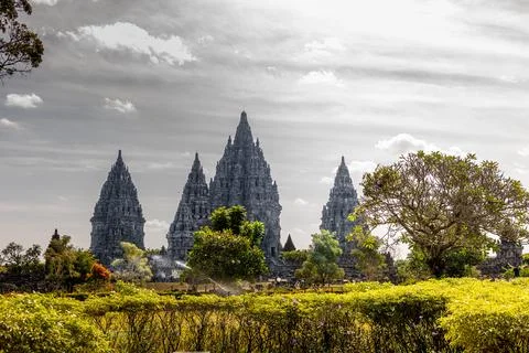 Ancient Hindu temple Prambanan complex with stone carvings and stupas under.. Stock Photos
