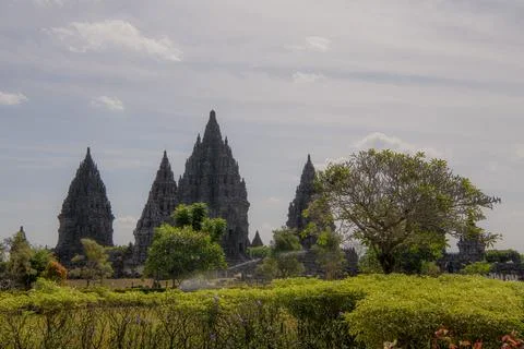 Ancient Hindu temple Prambanan complex with stone carvings and stupas under.. Stock Photos