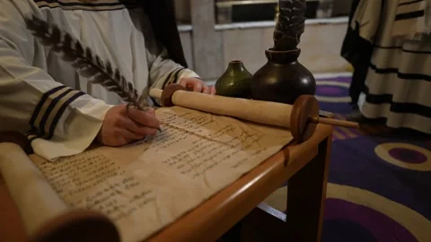 Ancient Historian Writing on Parchment Scroll with Quill Documenting Events 스톡 동영상 297457377