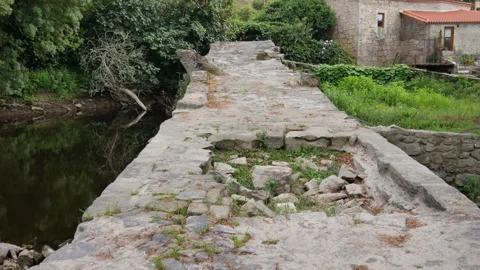 Ancient, historic stone bridge, built during medieval period in Portugal Stock Footage 248447695