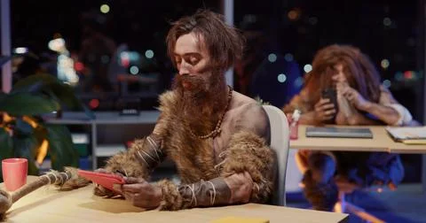 Ancient Human Young Caveman Using Tablet Technology Interacting Modern Apps Stock Photos