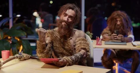 Ancient Human Young Caveman Using Tablet Technology Interacting Modern Apps Stock Photos
