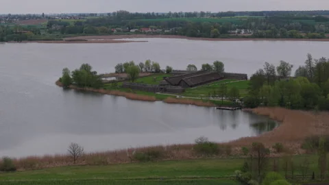 The ancient huts and defensive wall. Biskupin museum on the lake, Poland. Stock Footage 307290801
