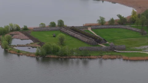 The ancient huts and defensive wall. Biskupin museum on the lake, Poland. Stock Footage 307290910