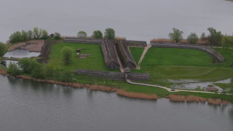 The ancient huts and defensive wall. Biskupin museum on the lake, Poland. Stock Footage 307290920