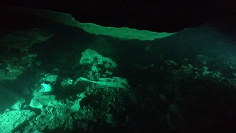 Ancient Illuminated Artifacts in a Dark Red Cave Qızıl Qoba , Crimea , Russia Stock Footage 82299081