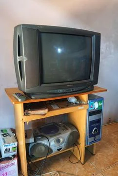 Ancient items on a computer desk. A sharp tube television, an ancient compute Foto stock