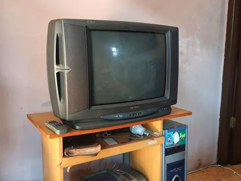 Ancient items on a computer desk. A sharp tube television, an ancient compute Foto stock