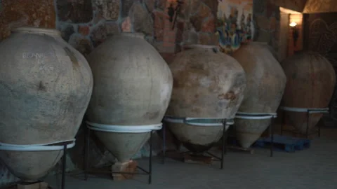Ancient jugs for wine called karas. Ceramic large jugs with wine in the cellar Stock Footage 201306885