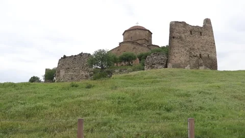 Ancient Jvari Monastery and stone fortress ruins on green hill Видео 340969846