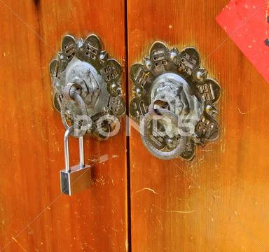 Ancient Knockers And Modern Lock Closeup In Taiwan