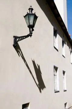 Ancient lantern on a wall Фото