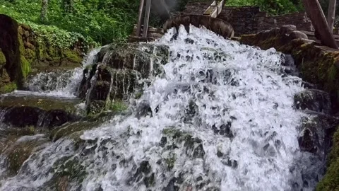 Ancient laundry on a river for washing carpets bara slow motion video Stock Footage 313013372