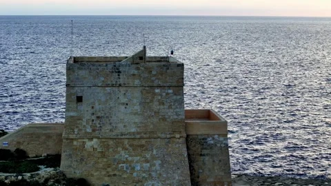 Ancient limestone Dwejra Tower stands as a silent sentinel over the deep blue Stockbeeldmateriaal 331110052