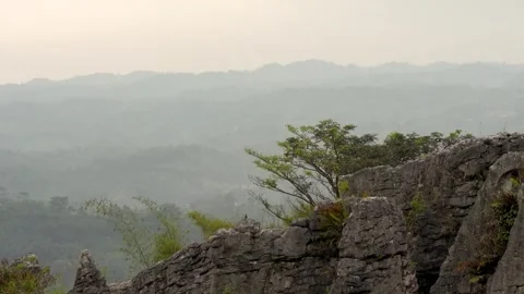 Ancient Limestone Karst Formations Overlooking Hazy Mountain Valley Stock Footage 343647861