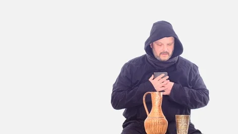 Ancient man in black overall  drinking grey screen dolly shot Video stock 105011609