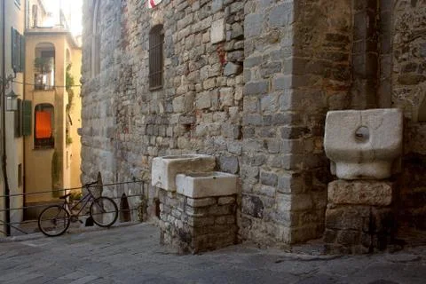 Ancient marble basins resting on the wall of a building in the historic center Фото