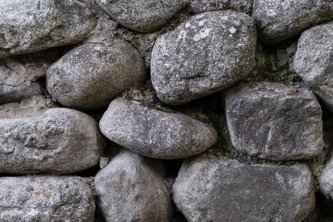 Ancient masonry wall built with natural gray river stones 库存照片